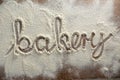 The word bakery written on sprinkled flour