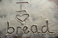 The word I love bread written on sprinkled flour