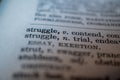 Close up of word struggle in dictionary