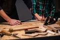 Close-up of the work of a man and a boy at a carpenter`s table, on the table are a plane, chisel, Board, workbench