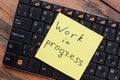 Close-up of work in progress sticky note message on keyboard. Royalty Free Stock Photo