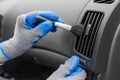 Close up of worker cleaning automobile air conditioner vent grill with brush. Car wash service Royalty Free Stock Photo