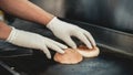 Close up. Worker Cooking Burger in Food Truck. Street Food Concept. Food in Town. Selling Snacks. Preparation of Sandwich.