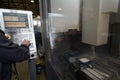 close up a worker hand or engineer introducing a program into a modern CNC machine. The concept of industry and