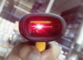 close up worker hand holding barcode scanner with scanning red laser Royalty Free Stock Photo