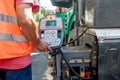 Close up of worker hand operating asphalt paver machinery Royalty Free Stock Photo