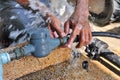 Close-up of worker hands plumbing unscrew connecting pipe while