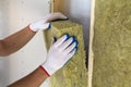 Close-up of worker hands in white gloves insulating rock wool insulation staff in wooden frame for future walls for cold barrier. Royalty Free Stock Photo