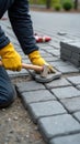 Close-Up of Worker Installing Interlocking Paving Stones with Precision
