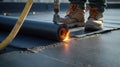 Close-Up of Worker Installing Waterproof Bitumen Membrane with Torch-On Method