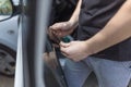 Close up of worker pulling off sun protection tinted foil from side car window Royalty Free Stock Photo