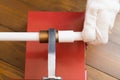 Close-up, workerÃ¢â¬â¢s hand in white gloves, installation process, adhesions of polypropylene pipes, on a wooden table