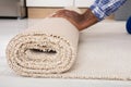 Worker`s Hands Rolling Carpet Royalty Free Stock Photo