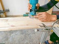 close up worker using electric wood router making beauty pattern on wood part of furniture hand made Royalty Free Stock Photo