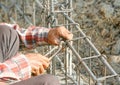 Worker using steel tool for bending steel by his hand for make fence construction Royalty Free Stock Photo