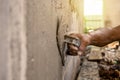 Close-up of workers using plaster trowel to plaster the walls for house construction, working ideas.