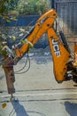 close up of working JCB Backhoe digging on road