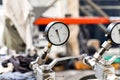 Close-up of a working pressure gauge of a hydraulic oil station in a workshop