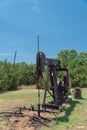 Working pump jack pumping crude oil at oil drilling site in rural USA Royalty Free Stock Photo