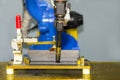 Close up workpieces set up tee joint on table for electric mig welding process by robot at factory Royalty Free Stock Photo