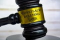 Close up of Workplace Bullying Laws text engraved on gavel Royalty Free Stock Photo