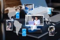 Close up of workplace with devices and creative globe map with computer screens and creative video conference call between Royalty Free Stock Photo