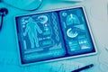 Close up of workplace with pad, supplies, stethoscope, glowing blue medical interface. Healthcare, technology, medicine and Royalty Free Stock Photo