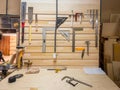 Close-up of workshop tool wall featuring screwdriver, ruler, clamp, wrench, pliers, and precision carpentry gear for Royalty Free Stock Photo