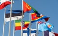 Close up of world flags flying in a row outside of expo center in 2020 waving on blue sky background Ethiopia, Finland, Eswantini