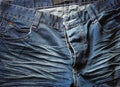 Close up of worn blue jeans.