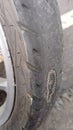 A close up of a worn and almost torn front tire of a motorcycle. Royalty Free Stock Photo