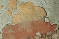 Worn wall with plaster covered by peeled paint Royalty Free Stock Photo