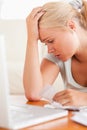 Close up of a Worried blond woman accounting