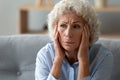 Close up worried elderly 70s woman deep in sad thoughts Royalty Free Stock Photo