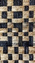 Close-up of woven straw and black thread texture, detailed pattern. Rustic craft and textile design concept Royalty Free Stock Photo