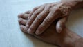 Close up of wrinkled elderly man`s hands. An elderly retiree put his hands on the table, tired of work. Elderly people and lonelin