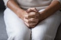 Close up wrinkled female hands clasped together on lap. Royalty Free Stock Photo