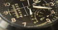 Close up wrist watch, chronograph, chronometer, analog, close up hour and minute hand, black background, close up watch