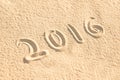 Close up on 2016 written in the sand