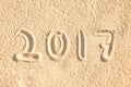 Close up on 2017 written in the sand