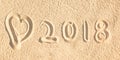 Close up on 2018 written in the sand of a beach wih a heart Royalty Free Stock Photo