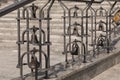 Close-up of wrought church bells in iron balustrade of outdoors staircase