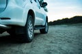 Close up 4x4 off road car vehicle standing on the sandy surface in beach with trailer d Royalty Free Stock Photo