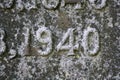 Number carved in diorite granite covered with lichen 1940