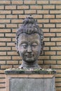 Close-up 400 years old of ancient head stone buddha statue at historical museum Thailand, art crafting sculpture