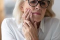 Close up 60 years old unhappy businesswoman having toothache. Royalty Free Stock Photo