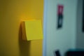 Close-up of a yellow adhesive sticker on a yellow wall, ai generated Royalty Free Stock Photo