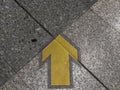 Close up Yellow arrow on floor ground. Royalty Free Stock Photo