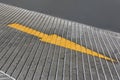Close up Yellow Arrow signs as road markings. Arrow sign on slope floor at park building Royalty Free Stock Photo