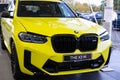 close-up yellow BMW 5-door petrol crossover model X3 M in Studio, Exterieur vehicle in showroomr, German brand automotive